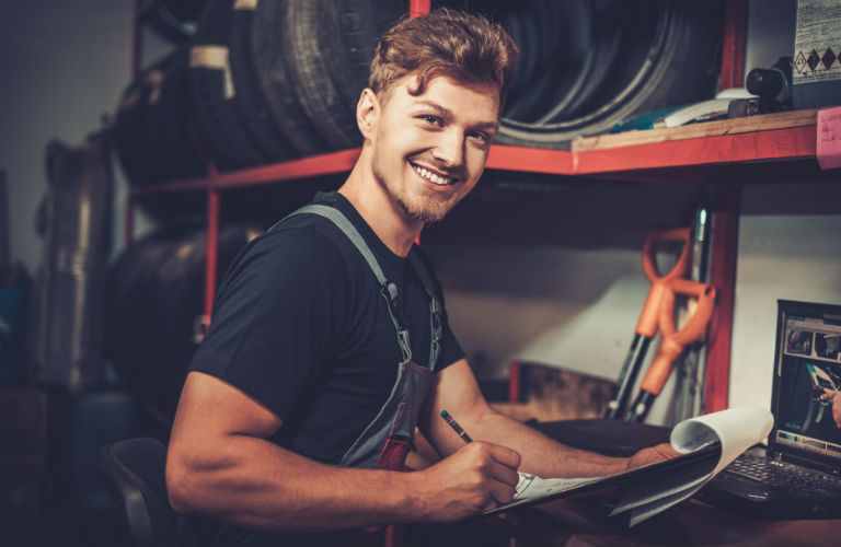 Male car mechanic smiling