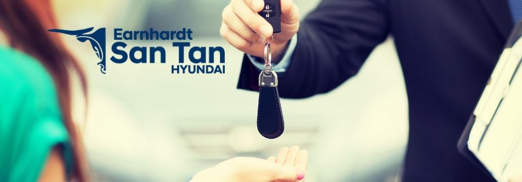 Car Dealer Handing Keys to a Woman with San Tan Hyundai Logo