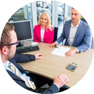 Car Salesman at a Desk with Man and Woman