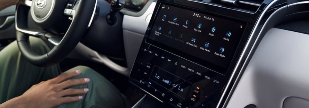 Woman Connecting to Bluetooth on Touchscreen Display in 2022 Hyundai Tucson